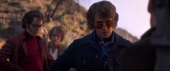 Movie still from “Elvis” (2022), directed by Baz Luhrmann – A man in a blue jacket and a man in a brown jacket; Medium shot, Over the shoulder angle