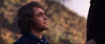 Movie still from “Elvis” (2022), directed by Baz Luhrmann – A person looking up at the sky; Close Up shot, Over the shoulder angle