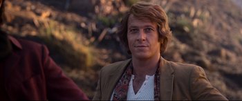 Movie still from “Elvis” (2022), directed by Baz Luhrmann – A person with long hair; Close Up shot, Over the shoulder angle