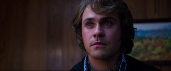 Movie still from “Elvis” (2022), directed by Baz Luhrmann – A person with long hair; Close Up shot, Low angle