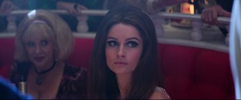 Movie still from “Elvis” (2022), directed by Baz Luhrmann – A beautiful woman with long hair and blue eyes; Close Up shot, Over the shoulder angle