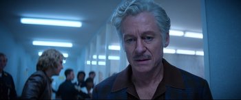 Movie still from “Elvis” (2022), directed by Baz Luhrmann – An older man with white hair looking at the camera; Close Up shot, Low angle