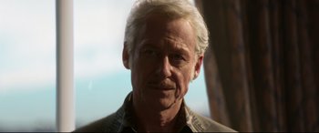 Movie still from “Elvis” (2022), directed by Baz Luhrmann – An older man with white hair looking at the camera; Close Up shot, Low angle