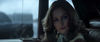 Movie still from “Elvis” (2022), directed by Baz Luhrmann – A beautiful young woman with long brown hair and blue eyes; Close Up shot, Over the shoulder angle