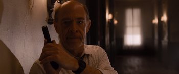 Movie still from “The Accountant” (2016), directed by Gavin O'Connor – An older man wearing a white dress shirt and tie; Close Up shot, Low angle