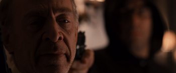 Movie still from “The Accountant” (2016), directed by Gavin O'Connor – A person with a cell phone; Close Up shot, Over the shoulder angle