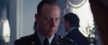Movie still from “The Accountant” (2016), directed by Gavin O'Connor – A man in a military uniform is looking down; Close Up shot, Over the shoulder angle