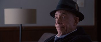 Movie still from “The Accountant” (2016), directed by Gavin O'Connor – An older man wearing a black hat and a black jacket; Close Up shot, Over the shoulder angle