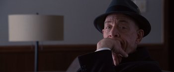 Movie still from “The Accountant” (2016), directed by Gavin O'Connor – An older man wearing a black hat and a black suit; Close Up shot, Over the shoulder angle