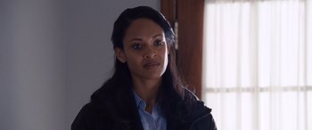 Movie still from “The Accountant” (2016), directed by Gavin O'Connor – A woman with long black hair wearing a black jacket; Close Up shot, Over the shoulder angle