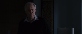 Movie still from “The Accountant” (2016), directed by Gavin O'Connor – An older man in a black shirt is looking at the camera; Medium shot, Over the shoulder angle