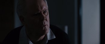 Movie still from “The Accountant” (2016), directed by Gavin O'Connor – An older man is looking into the distance; Close Up shot, Over the shoulder angle
