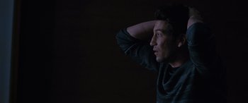 Movie still from “The Accountant” (2016), directed by Gavin O'Connor – A young man is looking into the distance with his hand on his head; Close Up shot, High angle