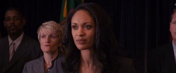 Movie still from “The Accountant” (2016), directed by Gavin O'Connor – A woman that is looking at the camera; Close Up shot, Over the shoulder angle