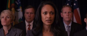 Movie still from “The Accountant” (2016), directed by Gavin O'Connor – A woman standing in front of two other men; Close Up shot, Over the shoulder angle