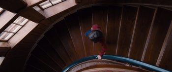 Movie still from “The Accountant” (2016), directed by Gavin O'Connor – A person climbing up a wooden spiral staircase; Wide shot, Overhead angle