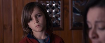 Movie still from “The Accountant” (2016), directed by Gavin O'Connor – A little girl is looking at the camera; Close Up shot, Over the shoulder angle