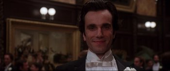 Movie still from “The Age of Innocence” (1993), directed by Martin Scorsese – A person wearing a suit and bow tie; Close Up shot, Low angle