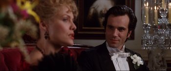 Movie still from “The Age of Innocence” (1993), directed by Martin Scorsese – A man and a woman sitting next to each other in a room; Close Up shot, Over the shoulder angle