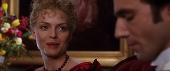 Movie still from “The Age of Innocence” (1993), directed by Martin Scorsese – A person wearing a red dress; Close Up shot, Over the shoulder angle