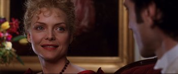 Movie still from “The Age of Innocence” (1993), directed by Martin Scorsese – A person wearing a red dress; Close Up shot, Over the shoulder angle