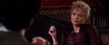 Movie still from “The Age of Innocence” (1993), directed by Martin Scorsese – A woman smoking a cigarette in front of a mirror; Close Up shot, Over the shoulder angle