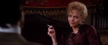 Movie still from “The Age of Innocence” (1993), directed by Martin Scorsese – A woman is holding a cigarette in her hand; Close Up shot, Low angle