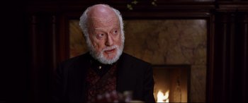 Movie still from “The Age of Innocence” (1993), directed by Martin Scorsese – An old man with a beard and a suit; Close Up shot, Over the shoulder angle