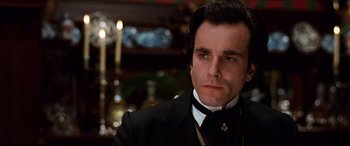 Movie still from “The Age of Innocence” (1993), directed by Martin Scorsese – A person wearing a suit and tie; Close Up shot, Low angle