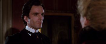 Movie still from “The Age of Innocence” (1993), directed by Martin Scorsese – A person wearing a suit and tie; Close Up shot, Low angle