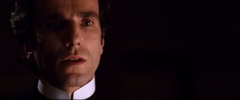 Movie still from “The Age of Innocence” (1993), directed by Martin Scorsese – A person wearing a suit and tie; Close Up shot, Low angle