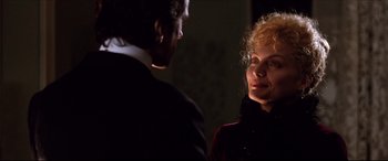 Movie still from “The Age of Innocence” (1993), directed by Martin Scorsese – A man and a woman standing next to each other in the dark; Close Up shot, Over the shoulder angle
