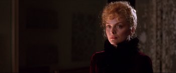 Movie still from “The Age of Innocence” (1993), directed by Martin Scorsese – A woman in a black jacket is looking at the camera; Close Up shot, Low angle