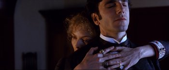 Movie still from “The Age of Innocence” (1993), directed by Martin Scorsese – A man and a woman embracing each other in the dark; Close Up shot, Low angle