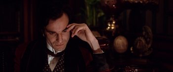 Movie still from “The Age of Innocence” (1993), directed by Martin Scorsese – A person wearing a suit and tie; Close Up shot, High angle