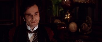 Movie still from “The Age of Innocence” (1993), directed by Martin Scorsese – A person wearing a suit and tie; Close Up shot, Low angle