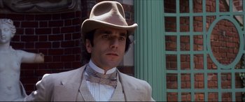 Movie still from “The Age of Innocence” (1993), directed by Martin Scorsese – A person wearing a hat and a bow tie; Close Up shot, Low angle