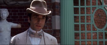 Movie still from “The Age of Innocence” (1993), directed by Martin Scorsese – A person wearing a hat and a suit; Close Up shot, Over the shoulder angle