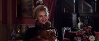 Movie still from “The Age of Innocence” (1993), directed by Martin Scorsese – A woman holding a small dog in her arms; Close Up shot, Over the shoulder angle