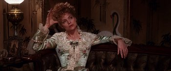 Movie still from “The Age of Innocence” (1993), directed by Martin Scorsese – A woman sitting on top of a couch in a room; Close Up shot, Low angle