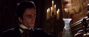 Movie still from “The Age of Innocence” (1993), directed by Martin Scorsese – A person wearing a suit and tie; Close Up shot, Over the shoulder angle