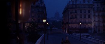 Movie still from “The Age of Innocence” (1993), directed by Martin Scorsese – A view of a city at night from a street; Extreme Wide shot, High angle