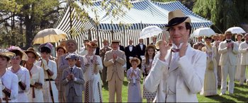 Movie still from “The Age of Innocence” (1993), directed by Martin Scorsese – A group of people standing in front of an outdoor tent; Medium shot, Low angle