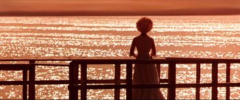 Movie still from “The Age of Innocence” (1993), directed by Martin Scorsese – A woman standing on a pier looking out at the water; Extreme Wide shot, Over the shoulder angle