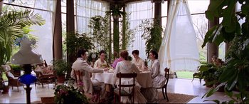 Movie still from “The Age of Innocence” (1993), directed by Martin Scorsese – A group of people sitting around a table; Wide shot, High angle