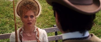 Movie still from “The Age of Innocence” (1993), directed by Martin Scorsese – A woman wearing a hat is looking at a man in a hat; Close Up shot, Over the shoulder angle
