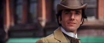 Movie still from “The Age of Innocence” (1993), directed by Martin Scorsese – A person wearing a hat and a suit; Close Up shot, Low angle