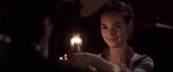 Movie still from “The Age of Innocence” (1993), directed by Martin Scorsese – A woman is holding a candle in her hand; Close Up shot, Over the shoulder angle