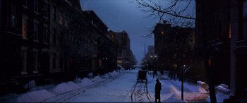 Movie still from “The Age of Innocence” (1993), directed by Martin Scorsese – A person is walking down a snowy street; Extreme Wide shot, High angle