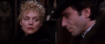 Movie still from “The Age of Innocence” (1993), directed by Martin Scorsese – A man and a woman sitting next to each other in a room; Close Up shot, Over the shoulder angle